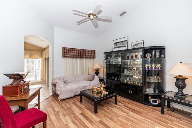 living room featuring high vaulted ceiling, ceiling fan, and light hardwood / wood-style flooring