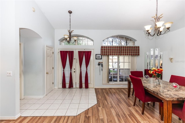 foyer entrance with an inviting chandelier and light hardwood / wood-style flooring