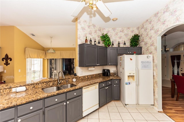 kitchen with light hardwood / wood-style floors, sink, white appliances, gray cabinetry, and vaulted ceiling