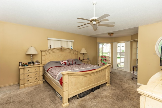 carpeted bedroom with a textured ceiling and ceiling fan