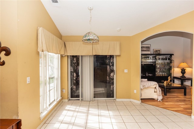 107 Needlewood Loop, Debary, FL 32713 - entryway featuring arched walkways, light tile patterned floors, baseboards, and vaulted ceiling