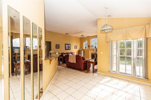 living room featuring light tile patterned floors, lofted ceiling, and ceiling fan