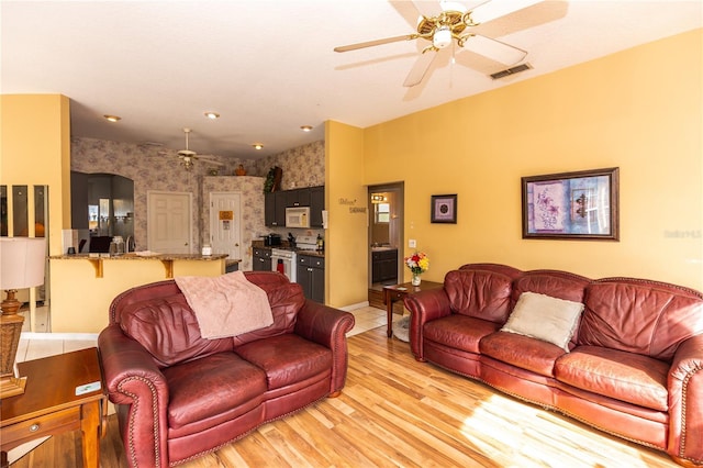 107 Needlewood Loop, Debary, FL 32713 - living room featuring wallpapered walls, ceiling fan, light wood-style flooring, and baseboards
