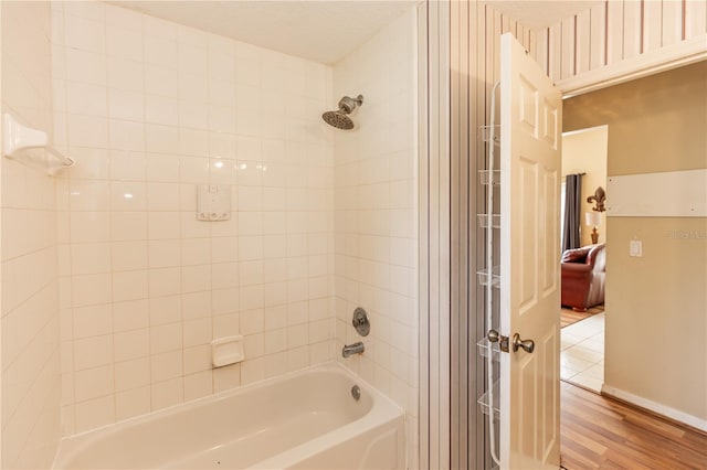 bathroom featuring hardwood / wood-style flooring and tiled shower / bath combo