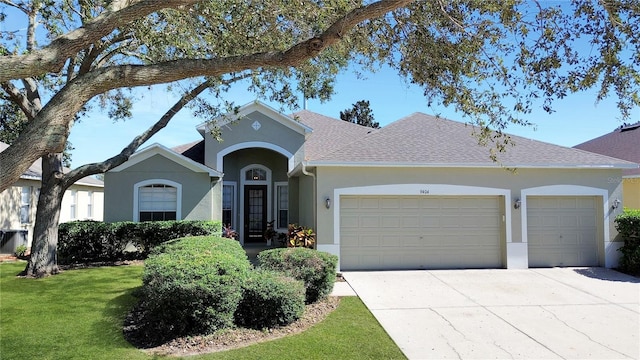 ranch-style home featuring a front lawn and a garage