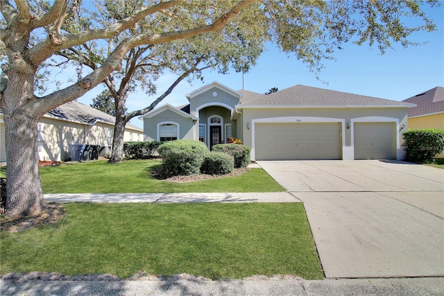 single story home featuring a front lawn and a garage