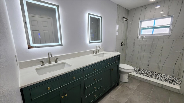 bathroom featuring a tile shower, toilet, and vanity