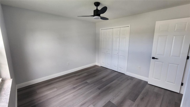 unfurnished bedroom with a closet, dark hardwood / wood-style floors, and ceiling fan