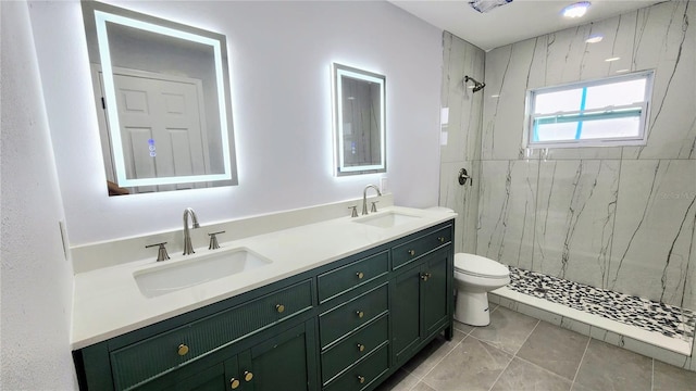 bathroom featuring vanity, toilet, and tiled shower