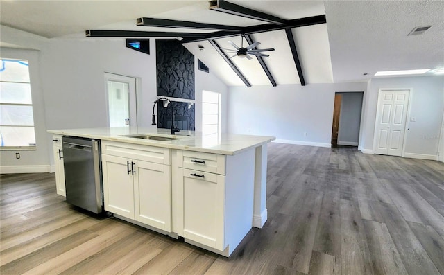 kitchen with dishwasher, white cabinets, sink, and a wealth of natural light