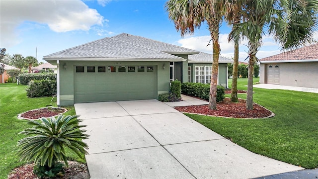 view of front of house with a garage and a front lawn