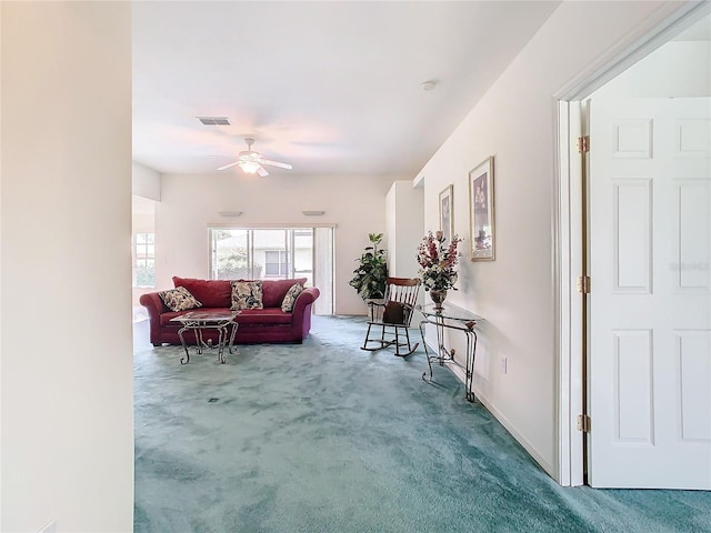 carpeted living room with ceiling fan