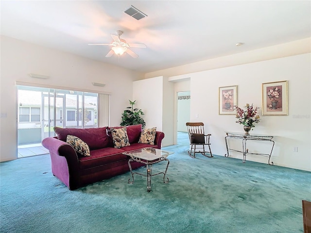 carpeted living room with ceiling fan