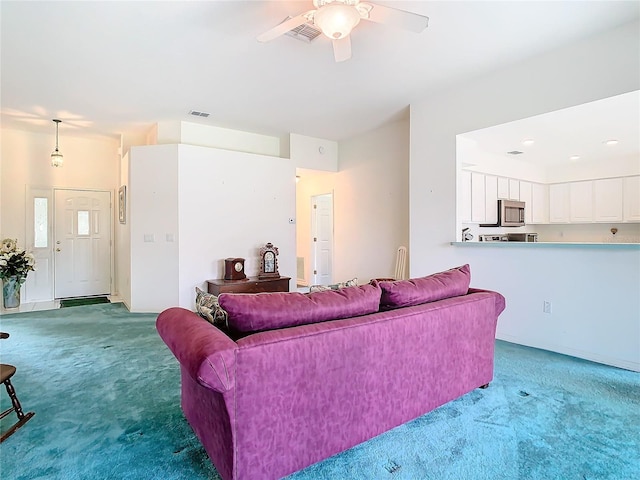 living room with ceiling fan and carpet floors