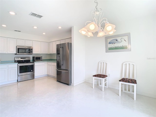 kitchen featuring decorative light fixtures, a notable chandelier, appliances with stainless steel finishes, and white cabinets