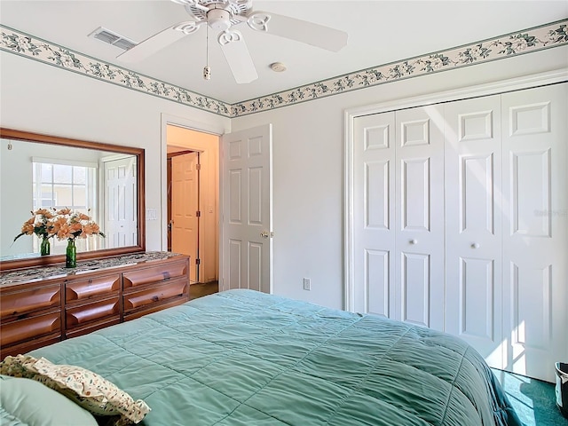 bedroom with ceiling fan and a closet