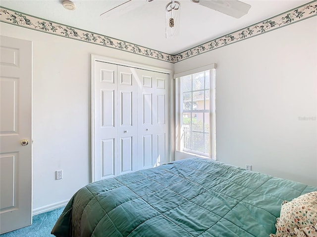 carpeted bedroom featuring a closet and ceiling fan