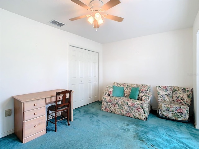 carpeted home office featuring ceiling fan