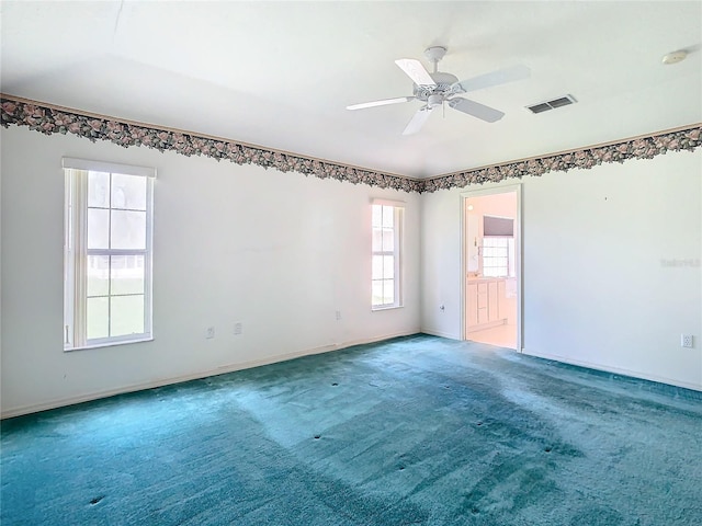 unfurnished room with ceiling fan and carpet flooring