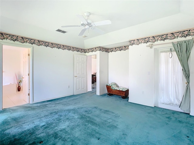 carpeted spare room featuring ceiling fan