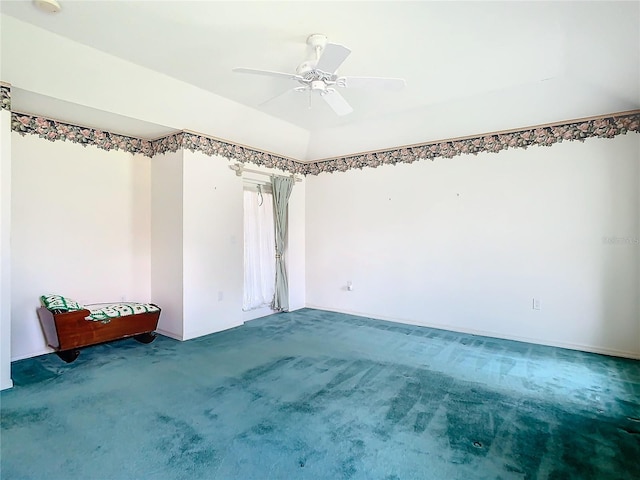 carpeted spare room featuring ceiling fan