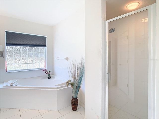 bathroom featuring tile patterned flooring and independent shower and bath