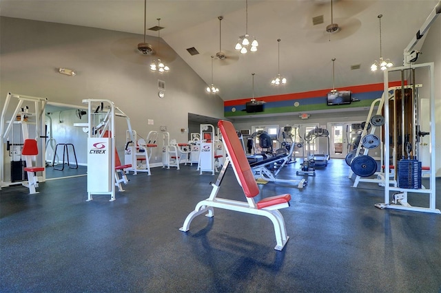 exercise room featuring high vaulted ceiling and ceiling fan