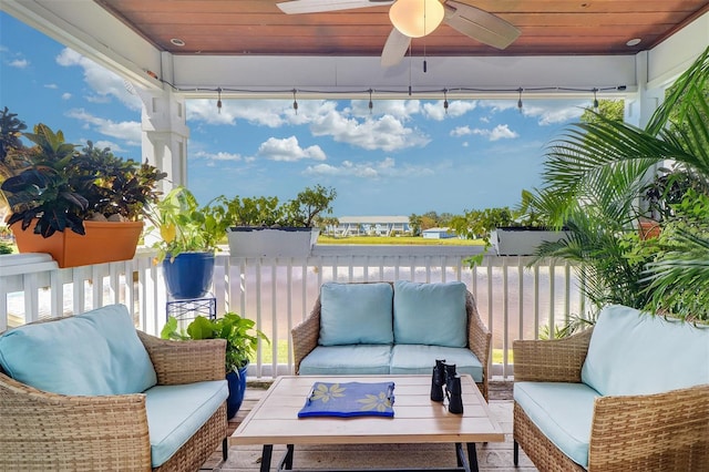 view of patio / terrace with a water view, ceiling fan, and an outdoor hangout area