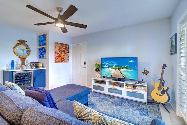 living room with ceiling fan, bar, dark hardwood / wood-style floors, and beverage cooler