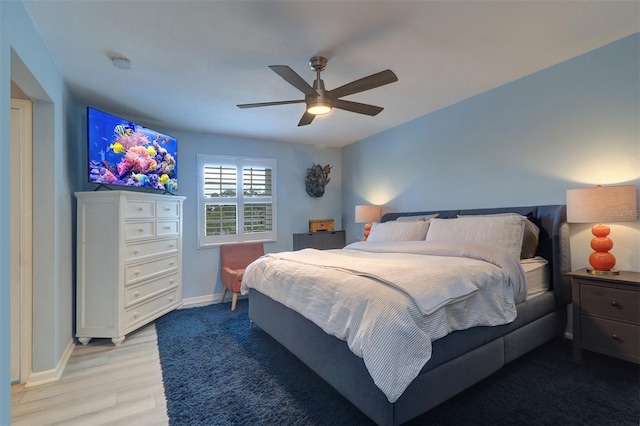 bedroom with light hardwood / wood-style floors and ceiling fan