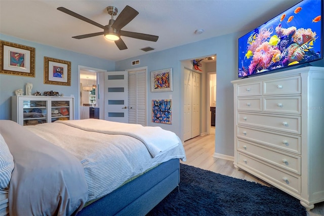 bedroom with a closet, ceiling fan, and light hardwood / wood-style flooring