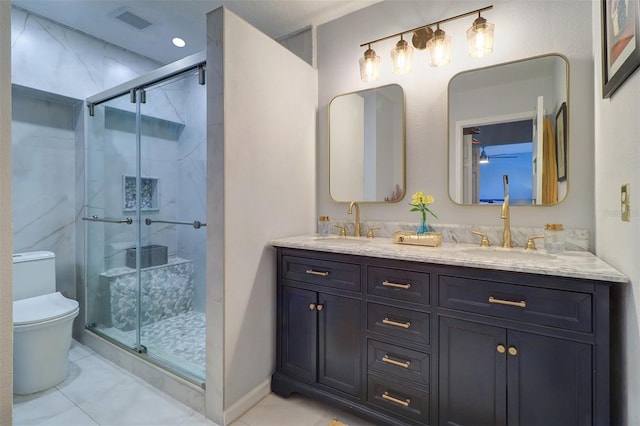 bathroom with vanity, toilet, a shower with shower door, and tile patterned flooring