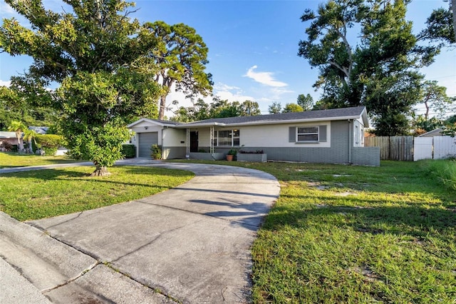 ranch-style house with a garage and a front lawn