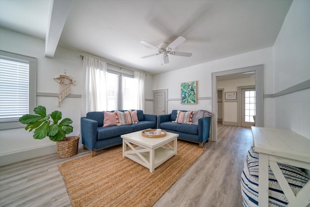 living room with light hardwood / wood-style floors and ceiling fan