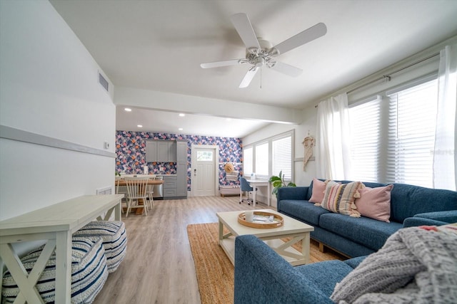 living room featuring light wood-type flooring and ceiling fan