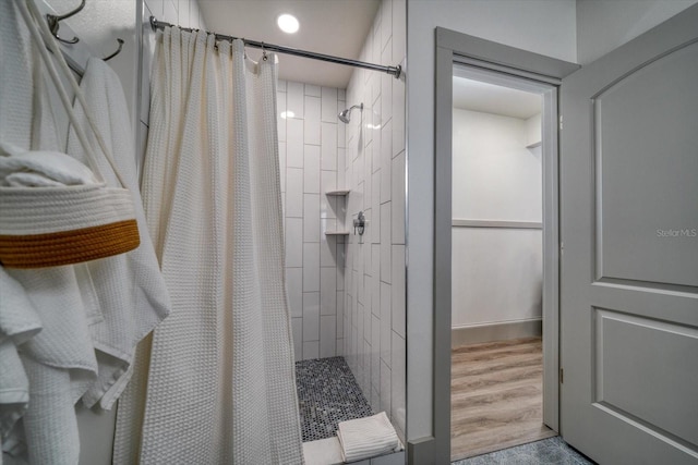 bathroom featuring hardwood / wood-style floors and curtained shower