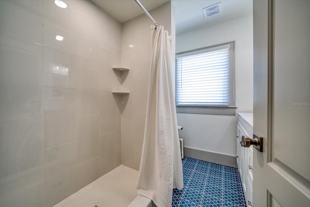 bathroom with walk in shower and tile patterned flooring