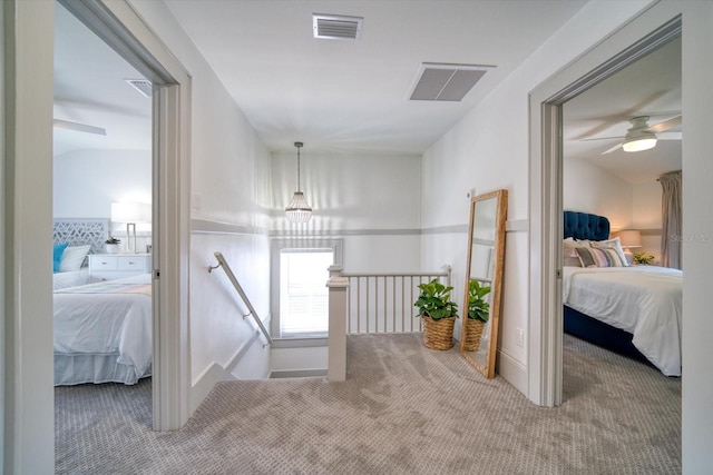 corridor with carpet and lofted ceiling