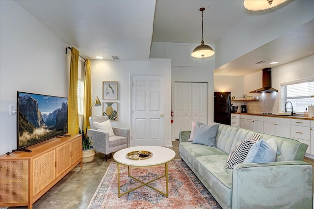 living room with concrete flooring and sink