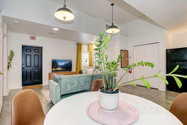 dining room featuring concrete flooring