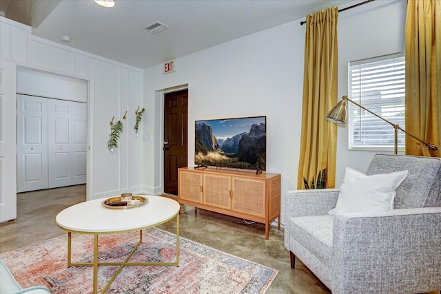 living room featuring concrete flooring