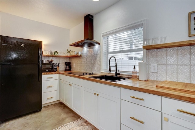 kitchen with decorative backsplash, white cabinetry, wall chimney exhaust hood, black appliances, and sink