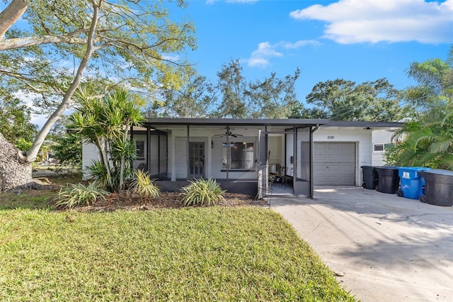 ranch-style home with a garage and a front yard