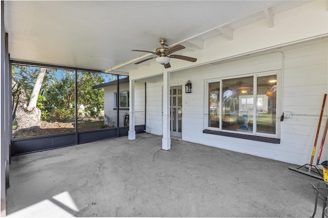 unfurnished sunroom with ceiling fan