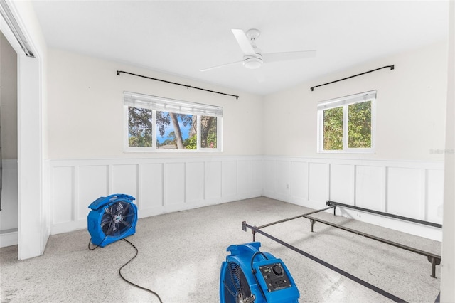 bedroom with ceiling fan and multiple windows