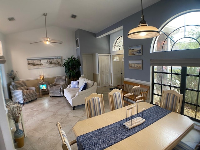 dining area with high vaulted ceiling and ceiling fan