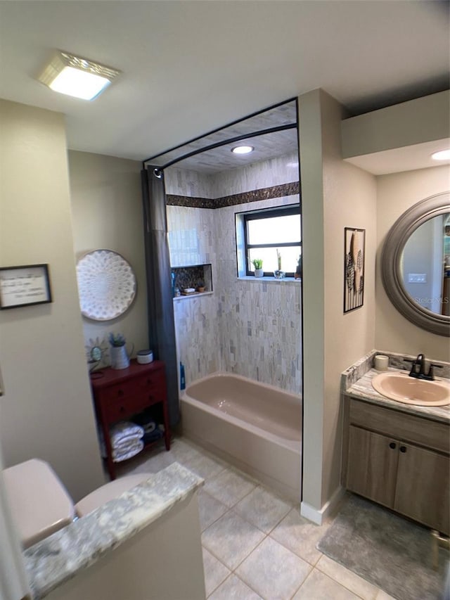 bathroom featuring vanity, tile patterned floors, and tiled shower / bath combo