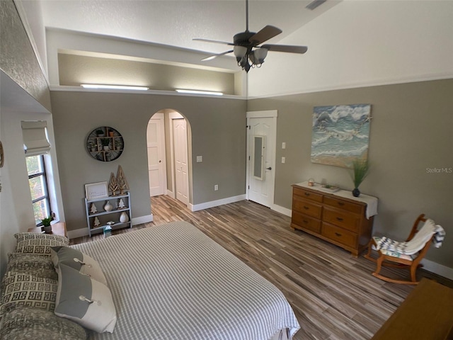 bedroom featuring ceiling fan, high vaulted ceiling, and wood-type flooring