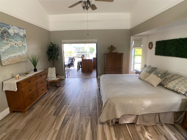 bedroom with ceiling fan, vaulted ceiling, and dark hardwood / wood-style floors