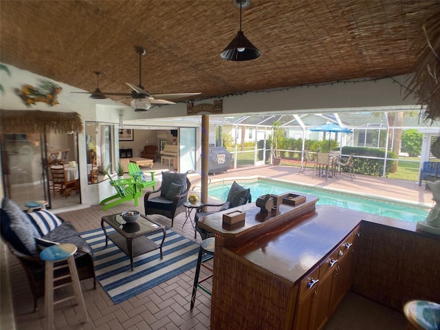 view of patio / terrace with an outdoor kitchen, a lanai, and ceiling fan